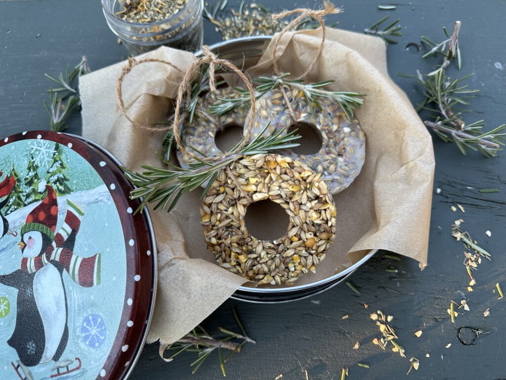 A winter themed tin is filled with homemade holiday suet cakes for birds.