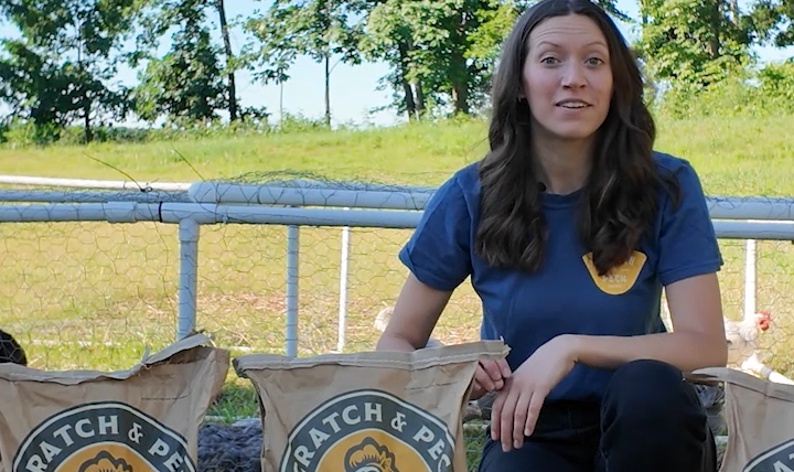 Woman sharing information about Scratch and Peck's organic poultry feeds and poultry supplements